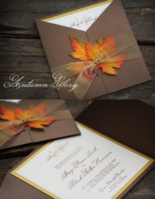 a brown wedding invitation suite done with bright fake fall leaves and some sheer ribbon for a fall wedding
