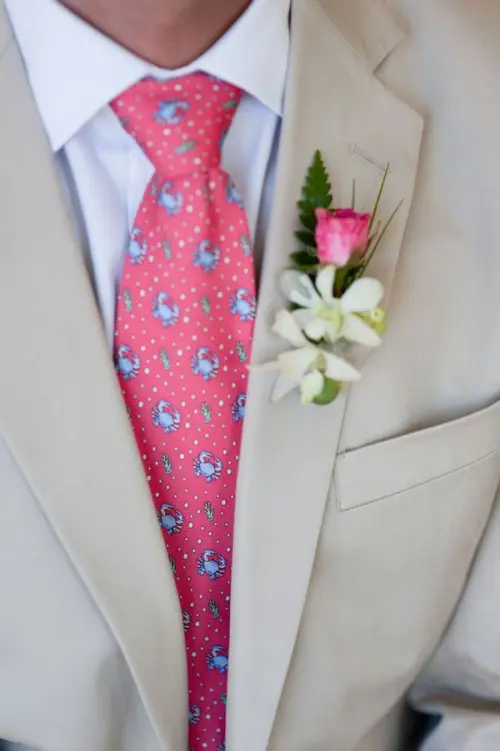 accent your tan suit with a bright printed tie and a boutonniere for a chic look