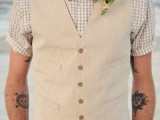 a relaxed summer groom’s look with a tan suit with a waistcoat, a plaid shirt and a printed bow tie