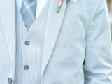 a refershing outfit with a light blue three-piece suit, a printed tie and a white shirt