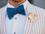 a whimsy groom’s look with a striped jacket, a bold blue bow tie and a sequin heart-shaped boutonniere