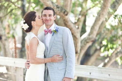 a light blue suit with a pink bow tie is a fersh color combo for a summer wedding