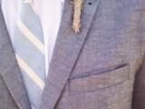a simple look with a grey suit, a striped tie and a greenery boutonnniere