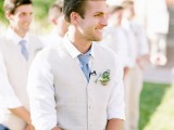 a neutral and comfortable groom’s look with a white shirt, a blue tie, a tan vest and pants