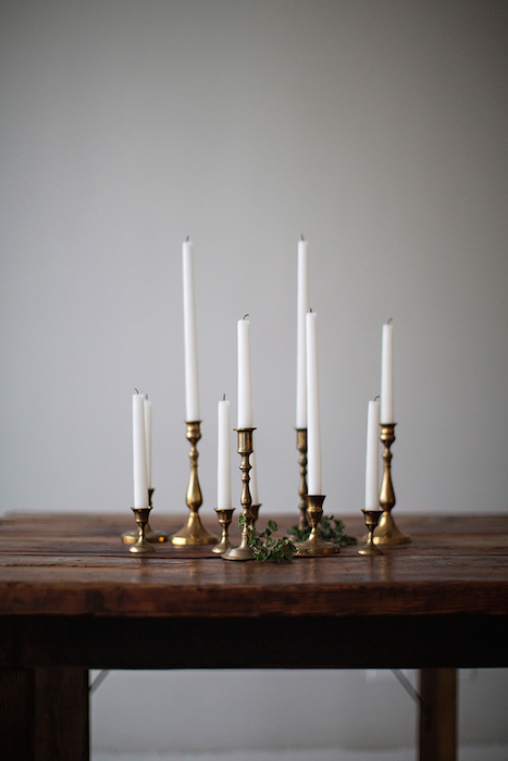 white candles in refined metallic candleholders as a bold minimalist wedding decoration