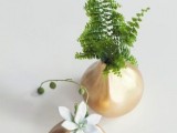 a minimalist wedding centerpiece of gilded vases with succulents and ferns is a stylish idea