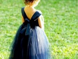 a navy mini ballgown with an open back and a tutu skirt for a little flower girl is a gorgeous idea