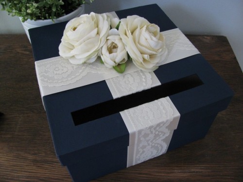 a navy card box with white lace and white blooms on top is a great idea to rock at the wedding