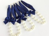 pearl necklaces with navy ribbons are chic accessories for bridesmaids or even a bride