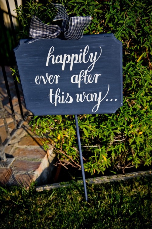 a navy and white sign with a plaid bow is a lovely wedding decor idea to go for