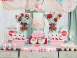 a sweet retro wedding dessert table with red, mint and grey paper fans, bright bloom arrangements, colorful popcorn paper bags