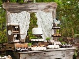 a rustic wedding dessert table of weathered wood, with crates and boxes and lots of sweets