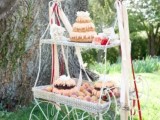 a whimsical dessert table styled as a wire cart, bright blooms and long ribbons and delicious sweets and desserts