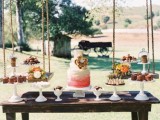 a creative rustic dessert table of wood and some swings to hold the desserts is a bold idea