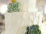 a white textural buttercream wedding cake decorated with succulents and billy balls is a cool idea for a mid-century modern wedding