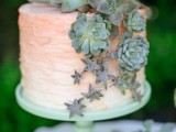 a peachy pink ombre wedding cake topped and decorated with various succulents of various sizes is a fresh and pretty idea with a touch of color
