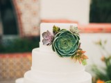 a sleek white buttercream wedding cake with decor composed of various types of succulents, in various colors, is a lovely idea for many weddings