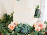 a white textural buttercream wedding cake with a greenery wreath, blush and light pink blooms and large succulents is a brilliant solution for a modern wedding with much greenery
