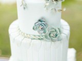 a light blue patterned buttercream wedding cake with rope decor and sugar succulents that look almost like natural ones but are absolutely edible