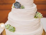a white ruffle tiered buttercream wedding cake decorated with succulents and with monogram cake toppers is a stylish idea to rock at a rustic wedding
