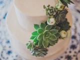 a sleek white wedding cake decorated with succulents and white blooms is a stylish and cool idea for a modern wedding in any style