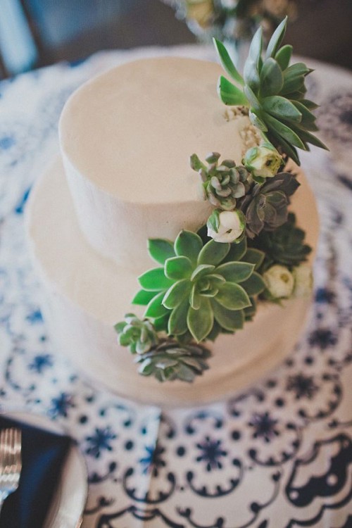 a sleek white wedding cake decorated with succulents and white blooms is a stylish and cool idea for a modern wedding in any style