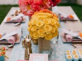 a colorful summer tablescape with a printed runner, bright blooms, pastel linens for a bold and cool space