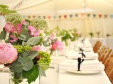 a summer wedding table done with bright pink blooms and greenery is a chic and bold idea to rock