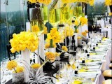 a contrasting summer wedding tablescape done in black, white and yellow, with statement florals, a black runner and neutral napkins