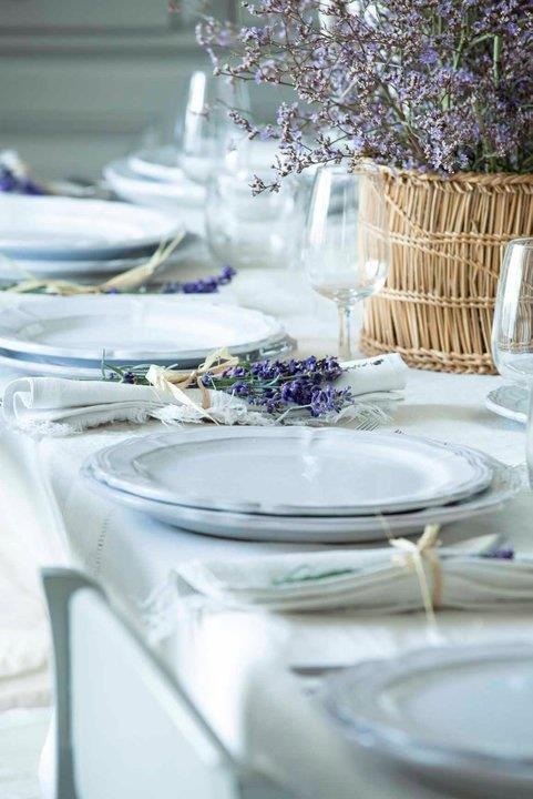 a neutral summer wedding tablescape with neutrla porcelain, linens, lavender and a statement lavender centerpiece