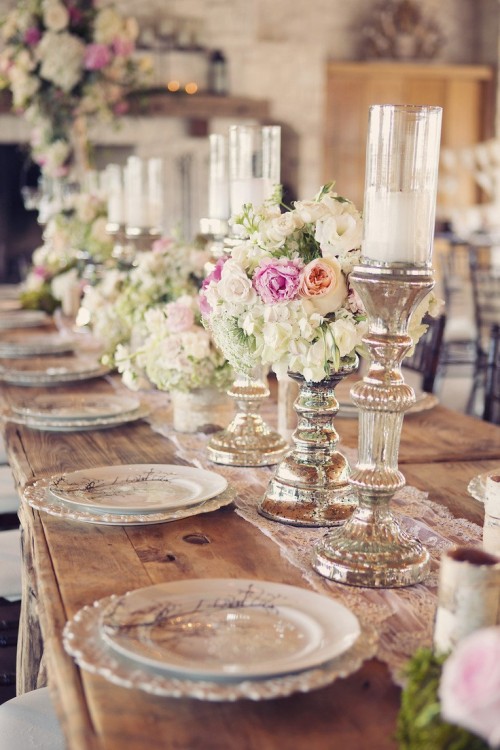 a refined vintage-inspired wedding tablescape with neutral blooms, candles in chic candleholders and a lace table runner