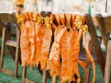 orange and rust ribbons can decorate the chairs instead of usual blooms or traditional colors giving them a touch of color