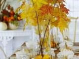 an all-natural fall and Thanksgiving tablescape natural pumpkins and bold fall foliage in vases is a lovely idea for your wedding or party