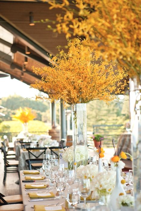 super tall and bold yellow floral centerpieces are perfection for a fall wedding of any kind, they will bring a touch of bold color to the space