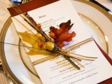 a stylish rustic and Thanksgiving place setting with a menu, with leaves and beads and rust touches is a cool idea