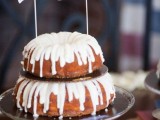 a tiered bundt cake with frosting with a bunting wedding cake topper is a lovely casual idea for a spring or summer wedding