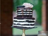 a naked chocolate wedding cake with chocolate drip, blackberries and a blush rose is a decadent and refined idea for a fall wedding