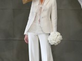 a stylish white pantsuit, a white lace bodysuit, a statement hat and white heels for an elegant look