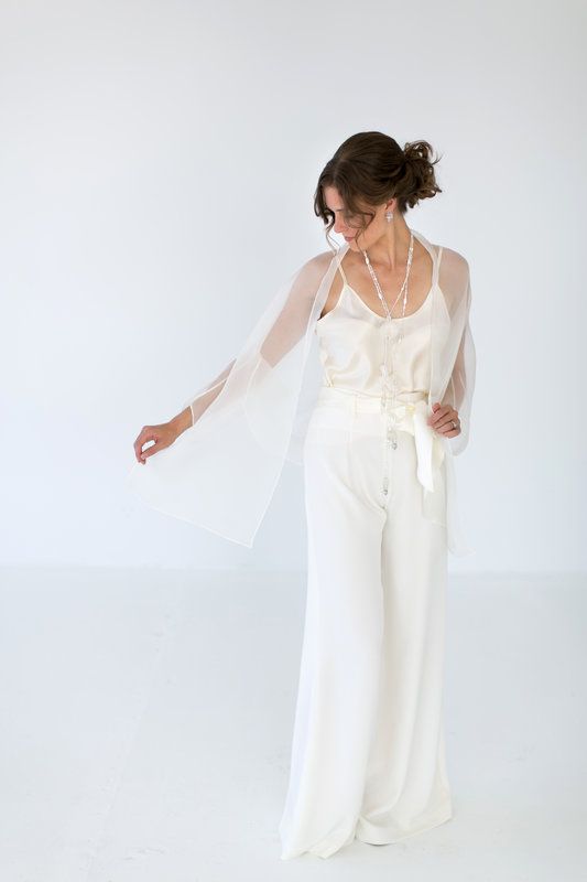 A white top, white palazzo pants, a sheer coverup, layered necklaces for a casual and chic bridal look