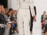 a chic white pantsuit with white pants, a sculptural white and sheer top with long sleeves for a retro-inspired look