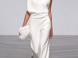 a minimalist bridal pantsuit with palazzo pants and an oversized one shoulder top for an ultra minimal look
