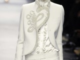 an haute couture pantsuit with pants, a catchy blazer with embroidery and a white silk blouse for a daring bride
