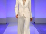 a modern bridal look with a white pantsuit with palazzo pants and a blazer with padded shoulders plus layered necklaces