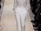 a glam bridal look with white pants and a fully embellished top with long sleeves plus white mules for a trendy bride