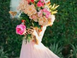a large wedding bouquet of peonies, roses and garden roses in beige and hot pink is a lovely idea for a spring or summer bride