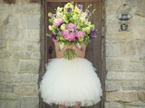 a bold oversized wedding bouquet of purple and pink blooms and greenery is a gorgeous idea for a summer bride and a wedding with color
