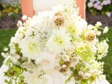 an oversized white wedding bouquet with plenty of texture and dimension, with greenery to give a more eye-catchy look to the arrangement