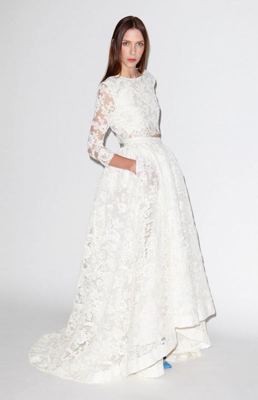 A chic and beautiful lace bridal separate with a crop top with a high neckline, long sleeves and a high low skirt with a train plus blue shoes