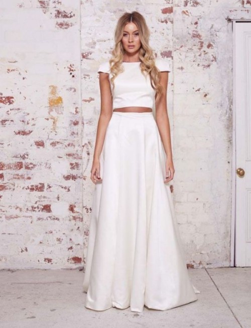 a minimalist bridal separate with a plain crop top with short sleeves and a pleated A-line maxi skirt is very elegant