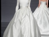 a white fitting long sleeve top with a high neckline and a shiny full skirt with a sash for a more formal look at the wedding